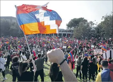  ?? A PROTESTER Myung J. Chun Los Angeles Times ?? waves the f lag of the self- proclaimed Republic of Artsakh, a majority- Armenian separatist region in Azerbaijan, as thousands gather in Pan Pacific Park before marching to the Turkish Consulate.