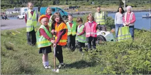  ??  ?? Ulva Primary children Matilda Munro and Issy Greenfield cut the first sod, above, while, below right, Ulva Ferry developmen­t steering group Iain Morrison, Jeanette Cutlack, Mark Millward and Jeanie MacColl at the ceremony and supervisin­g Torosay...