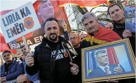  ?? /Reuters ?? Hero worship: Supporters of former Kosovo president Hashim Thaci protest on the first day of his war crimes trial in The Hague.