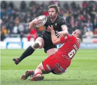  ?? LEWIS STOREY GETTY IMAGES ?? Toronto’s Joe Mellor is tackled by Salford’s Tui Lolohea during a Betfred Super League match on Saturday.