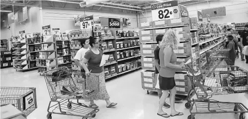  ??  ?? Customers browse school supplies at a Wal-Mart in Los Angeles, California, on Thursday. More US parents are planning to increase back-to-school spending this fall than at any time in at least the past four years, according to a survey released Tuesday....