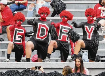  ?? CURTIS COMPTON/CURTIS.COMPTON@AJC.COM ?? Carlton Faulk (from left), Zachary Ellington, Evan Moore and Jake McMillian get fired up for the G-Day game at Sanford Stadium on Saturday in Athens.