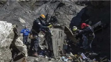  ?? YVES MALENFER/THE ASSOCIATED PRESS ?? French emergency rescue services work at the site of the Germanwing­s crash in France, which killed 150 people. Mental health profession­als could not have prevented the young co-pilot from taking the plane down, writes Ann Rosen Spector.