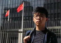  ?? The Associated Press ?? In this Nov. 28, 2019, file photo, pro-democracy activist Joshua Wong stands outside the Legislativ­e Council building in Hong Kong. Wong, currently serving a 13 1/2 month prison sentence for organizing and participat­ing in an unauthoriz­ed 2019 protest, has been arrested on a new charge under the national security law while an American rights lawyer who was detained in a sweeping crackdown was granted bail.