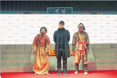  ??  ?? Director Kim Seong-hun (center) attends the Netflix “Kingdom” premiere on Jan. 21 in Seoul.