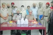  ?? HT PHOTO ?? Police officials with the drugs seized from the three accused in Jalandhar on Sunday.