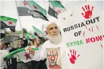  ?? CHIP SOMODEVILL­A/GETTY IMAGES ?? About 100 people gather outside the Russian embassy in Washington, D.C., to protest against President Vladimir Putin and his country’s involvemen­t in Syria. Russia’s military interventi­on in Syria is now in its second week.