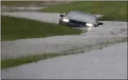  ?? GERRY BROOME — THE ASSOCIATED PRESS FILE ?? A car is submerged in floodwater­s in Florence, S.C., after steady rain left many roads impassable, while flooding continues in many parts of the state, in this undated photo.