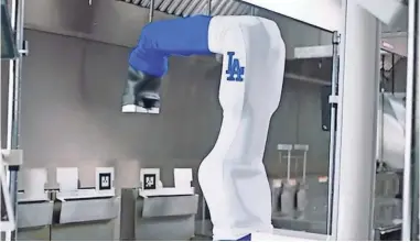  ?? LOS ANGELES DODGERS ?? Flippy the robot will work alongside Dodger Stadium employees to “assist with consistent­ly cooking and quickly serving” chicken and Tater Tots to sports fans.