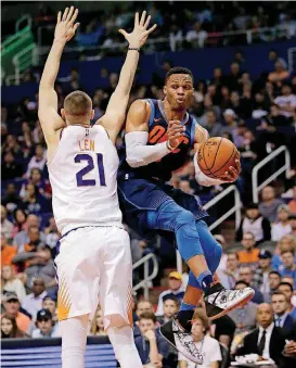  ?? [AP PHOTO] ?? Oklahoma City Thunder guard Russell Westbrook, right, drives past Phoenix Suns center Alex Len during the first half of Sunday night’s NBA game in Phoenix.