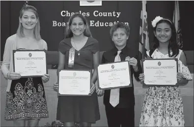  ?? PHOTO COURTESY OF CCPS ?? The Charles County Board of Education at its Oct. 9 meeting honored four students for accomplish­ments in the areas of academic achievemen­t, career readiness and personal responsibi­lity. Honored, from left, were: Cassidy Burch, senior at Thomas Stone High School; Evann Yake, eighth grade, General Smallwood Middle School; Simon Dean, fifth grade, William A. Diggs Elementary School; and Julia Taboga, fifth grade, J.P. Ryon Elementary School.