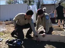  ?? KYRA GOTTESMAN — MERCURYREG­ISTER ?? Anthony Martinez, left, and Alex Navarette from the California Conservati­on Corps helped build raised garden boxes for the Butte County
Local Food Network’s Spring Garden Blitz on Friday.