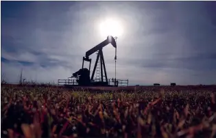  ?? CP FILE PHOTO ?? A pumpjack works at a well head on an oil and gas installati­on near Cremona, Alta., in this October 2016 file photo. A pair of Alberta landowners have filed a class-action lawsuit against AlphaBow Energy Ltd., over delinquent lease payments.