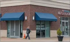  ?? RICH HUNDLEY III - FOR THE TRENTONIAN ?? A worker walks out of the InFocus Urgent Care to go out to cars for drive-up COVID-19 testing