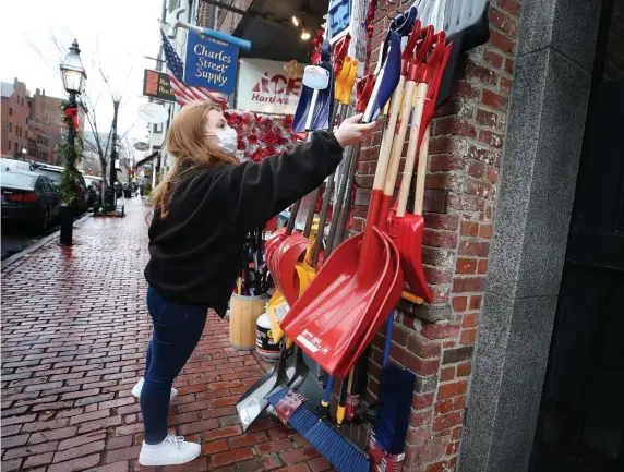  ?? NAncy LAnE / hErALd stAFF ?? SHOVELS FOR SALE: Abigail Cormier hangs out shovels at Charles Street Supply ahead of Wednesday’s upcoming storm.