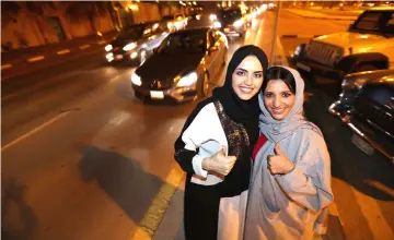  ??  ?? Saudi women celebrate after they drove their cars in Al Khobar. — Reuters photo