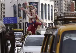  ?? — PTI ?? Devotees transport an idol of Lord Ganesh ahead of the Ganesh Chaturti in Mumbai on Sunday.