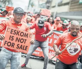  ?? /AFP ?? Power play: Cosatu members took to the streets on Wednesday as part of the trade federation’s oneday nationwide strike. Thousands of Durban members marched against the plan to restructur­e Eskom, which was announced by President Cyril Ramaphosa in his state of the nation address.