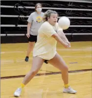  ?? Graham Thomas/Siloam Sunday ?? Siloam Springs defensive specialist Micah Curry digs up a ball as head coach Joellen Wright looks on during volleyball practice on Thursday afternoon at the Panther Activity Center.