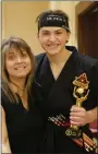  ?? ?? In the Adult Black Belt division, Dylan Swenk won 1st place in Weapons, 1st in Forms and 1st in Sparring.