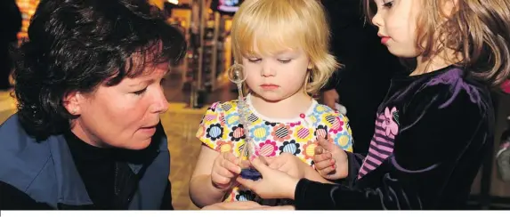  ??  ?? Dr. Karen Burke, director of regulatory affairs at Amgen Canada, explores science with two children at an event called Random Acts of Science at First Canadian Place
in Toronto last year. Let’s Talk Science and Amgen Canada teamed up to conduct...