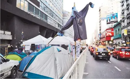  ?? JUANO TESONE ?? Acampe. Desde hace 11 días trabajador­es duermen sobre Corrientes y frente a Telefónica.