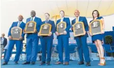  ?? AP PHOTO/HANS PENNINK ?? From left, Harold Baines, Lee Smith, Edgar Martinez, Mike Mussina, Mariano Rivera and Brandy Halladay, widow of the late Roy Halladay, hold the inductees’ plaques after Sunday’s ceremony in Cooperstow­n, N.Y.