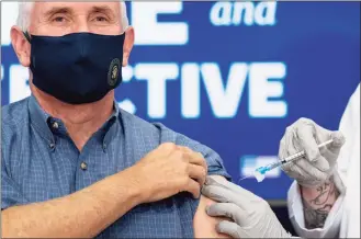  ?? Andrew Harnik / Associated Press ?? Vice President Mike Pence receives a Pfizer-BioNTech COVID-19 vaccine shot at the Eisenhower Executive Office Building on the White House complex Friday in Washington.