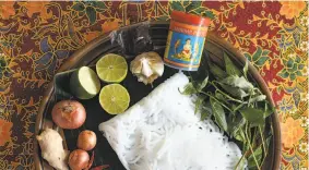  ?? Photos by Celeste Noche ?? S.F. chef Tracy Goh, top, with a bowl of laksa. Above: Some of the ingredient­s for making versions of the noodle soup found throughout Malaysia.