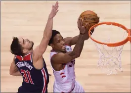  ?? CP PHOTO / NATHAN DENETTE ?? Toronto Raptors guard DeMar DeRozan (10) drives past Washington Wizards guard Tomas Satoransky (31) during second half round one NBA playoff basketball action in Toronto on Saturday.