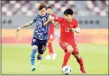  ??  ?? Japan’s Kyogo Furuhashi, (left), and China’s Jingdao Jin fight for possession during a FIFA World Cup qualifying soccer match between China and Japan in Doha, Qatar. (AP)