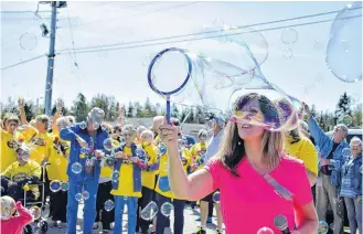  ??  ?? A bubble release in memory of those who have passed and in honour of those who have survived brought smiles to many faces during Walk for a Cause in support of the Rosalin Nickerson Care Fund. Founder Shelley d’Eon is in the foreground.