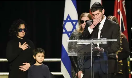  ?? NATHAN DENETTE/THE CANADIAN PRESS FILE PHOTO ?? An emotional Jonathon Sherman speaks at a memorial service in late December for his parents Barry and Honey Sherman, as family members look on.