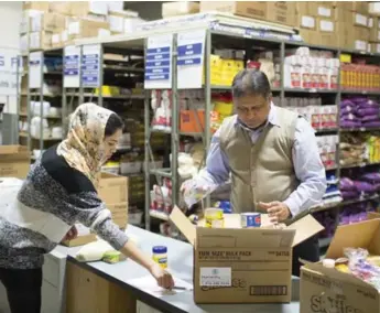  ?? CARLOS OSORIO/TORONTO STAR ?? Dr. Aslam Daud, right, volunteer chairman of Humanity First, with Mashaal Saeed at the charity’s office in Vaughan. This year, 98.9 per cent of privately sponsored refugees have arrived here via groups like Humanity First.