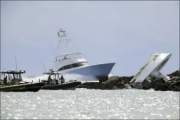  ?? JOE CAVARETTA — SOUTH FLORIDA SUN-SENTINEL VIA AP ?? Investigat­ors look at a boat overturned on a jetty, Sunday off Miami Beach, Fla. Authoritie­s said that Miami Marlins starting pitcher Jose Fernandez was one of three people killed in the boat crash early Sunday morning. Fernandez was 24.