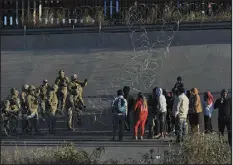  ?? CHRISTIAN CHAVEZ — THE ASSOCIATED PRESS ?? U.S. military members stop migrants from crossing into El Paso, seen from Ciudad Juarez, Mexico, on Tuesday.