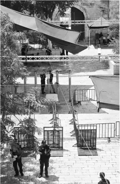  ??  ?? A picture shows security measures installed by Israeli authoritie­s, which include metal detectors and cameras outside Lions’ Gate, a main entrance to Al-Aqsa mosque compound in Jerusalem. — AFP photo