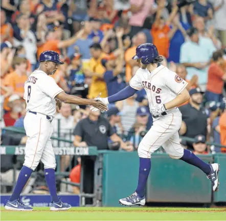  ?? Melissa Phillip / Houston Chronicle ?? Astros outfielder Jake Marisnick, right, accepts a congratula­tory handshake from third-base coach Gary Pettis after hitting a home run in the third inning. Marisnick had another in the fifth and had a total of five RBIs after doubling in the eighth.