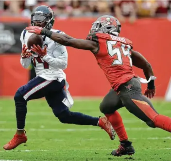  ?? Jason Behnken / Associated Press ?? Texans wideout DeAndre Carter caught a key pass for a first down against Buccaneers linebacker Lavonte David on Saturday after Carter replaced oft-injured receiver Will Fuller.