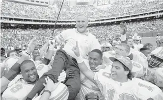  ?? GEORGE WIDMAN/AP ?? In this Nov. 14, 1993, file photo, Miami Dolphins coach Don Shula is carried on his team's shoulders after his 325th victory, against the Philadelph­ia Eagles in Philadelph­ia. Shula, who won the most games of any NFL coach and led the Miami Dolphins to the only perfect season in league history, died Monday at his South Florida home, the team said.
