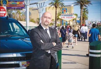  ?? CHRISTOPHE­R DEVARGAS ?? Carlos Camacho is owner of Universal Limousine Services and affiliate with Blacklane, which now offers luxury limousine service via a phone app from Las Vegas to Los Angeles for a flat fee. Camacho is pictured Friday near the Welcome to Las Vegas sign.