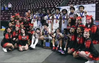  ?? BILL UHRICH — READING EAGLE ?? Reading High poses with the trophy following a District 3Class 6A 55-54overtime victory Thursday at the Giant Center.