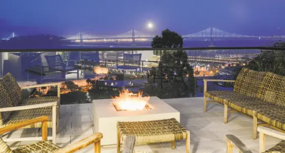  ?? PHOTOS BY DANIEL LUNGHI PHOTOGRAPH­Y ?? Above: The roof deck at 1400-1404 Montgomery St. in Telegraph Hill features a gas fire pit and looks out at the Bay Bridge. Below left: The owner’s suite resides on the third level and includes a sitting area and bay views. Below right: This spacious bedroom suite includes a wood-burning fireplace, built-in storage and a work station. The five-level home is listed for $8.99 million.