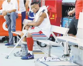  ?? MICHAEL REAVES/GETTY ?? The Giants’ Saquon Barkley looks on from the bench after suffering an ankle injury Sunday against the Buccaneers.