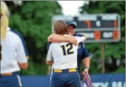  ?? THOMAS NASH — DIGITAL FIRST MEDIA ?? Pope John Paul II head coach Amanda Knight, back, gets a hug from catcher Grace Harvey (12) while distributi­ng the runner-up medals following the District 1-4A Championsh­ip game at Immaculata University.