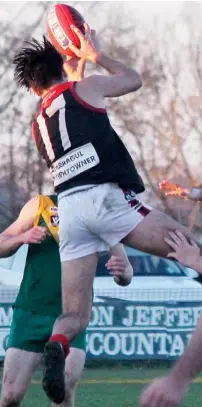  ??  ?? Jack Hudson, free on Saturday from Gippsland Power to play his second game with Warragul, takes a strong mark during the senior game at Leongatha. Photograph­s: Karen Baum