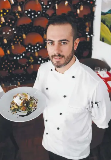  ?? Picture: STEWART McLEAN ?? FLAVOURSOM­E SERVE: C’est Bon head chef Daniel Peters with one of the new breakfast dishes on offer ‘The French C Word’ which is shredded duck, poached eggs, cheesy crushed potatoes, green leaves, beetroot balsamic reduction and crushed hazelnut.