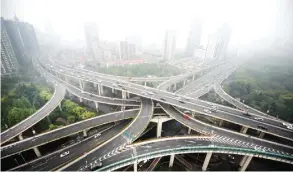  ??  ?? SHANGHAI: Photo shows cars on an elevated road on a heavy polluted day in Shanghai. Locking in an action plan to cap global warming at two degrees Celsius will be the ultimate yardstick for success or failure at the Paris climate summit that opens on...