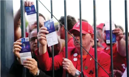  ?? ?? Liverpool fans stuck outside the ground show their match tickets before the Champions League final at the Stade de France. Photograph: Adam Davy/PA