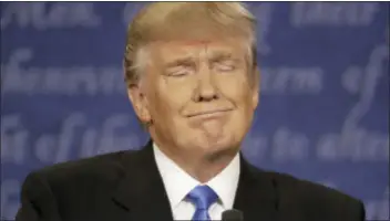  ?? PATRICK SEMANSKY — THE ASSOCIATED PRESS ?? Republican presidenti­al nominee Donald Trump listens to Democratic presidenti­al nominee Hillary Clinton during the presidenti­al debate at Hofstra University in Hempstead, N.Y., Monday.